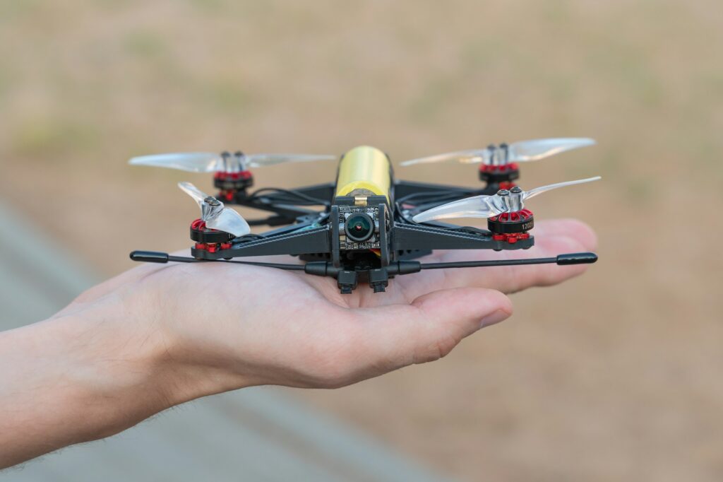 Safe quadcopter landing on the pilot's palm closeup. Man holding drone in his hand close up